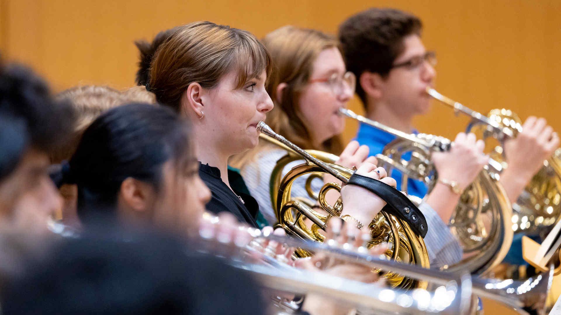 The horn section in an orchestra rehearsal